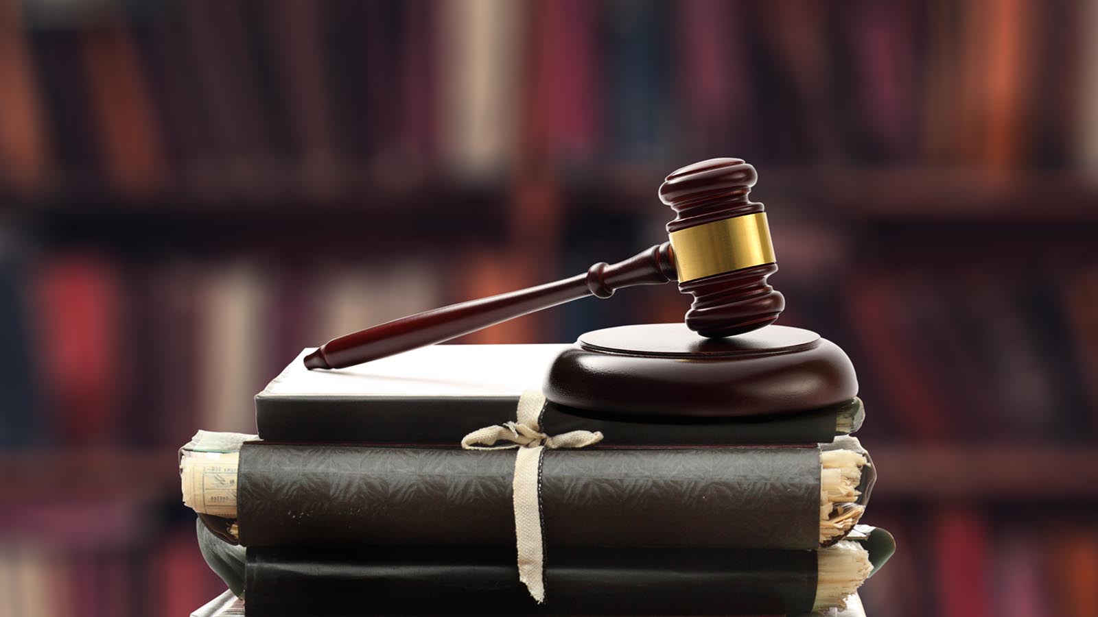 Gavel on an investigation folder A gavel lies on a pile of detective reports