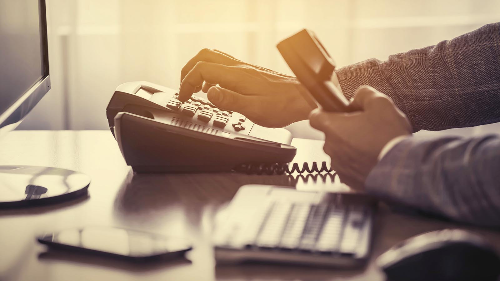 A private detective makes a call A private detective picks up a phone and dials a phone number